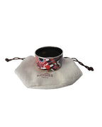 Hermès Pour Sortir brick red and multicolor enamel bangle bracelet with equestrian print and polished metal trim.
