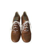 Michel Perry women's brown leather Oxford shoes with white contrast laces, rounded toe, and classic designer lace-up silhouette.