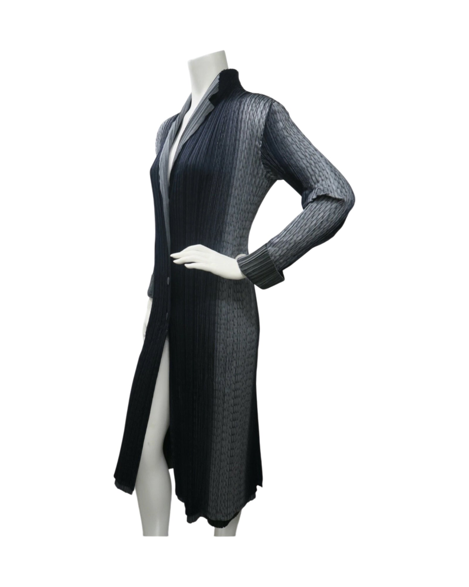 Issey Miyake Pleats Please reversible long pleated coat in gray charcoal and black with notched lapel and button-front closure.