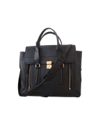 3.1 Phillip Lim Pashli large satchel in black pebbled leather with signature zip gussets, gold-tone hardware, and removable shoulder strap.