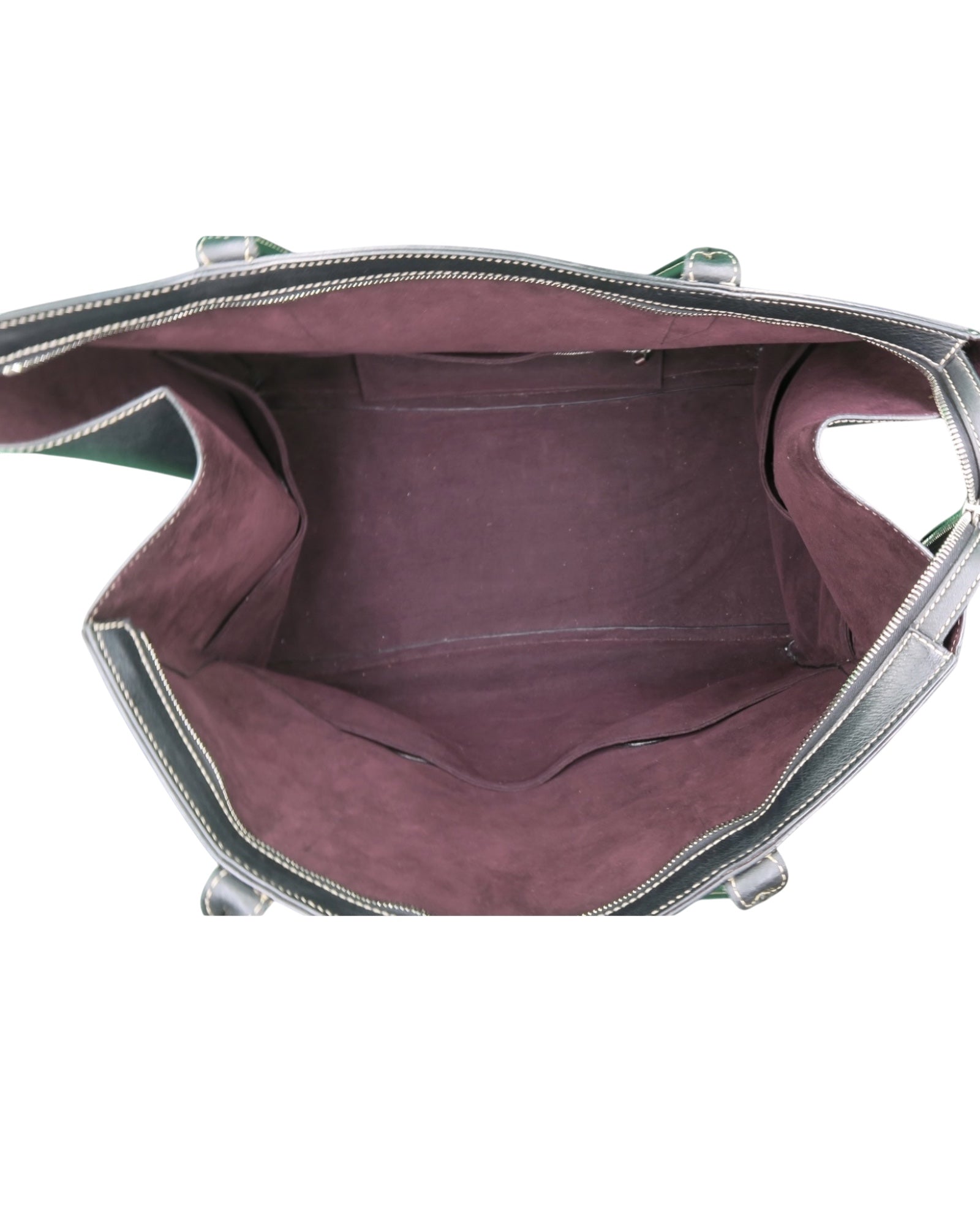 Métier black leather tote bag with dual top handles, structured silhouette and subtle logo detailing.