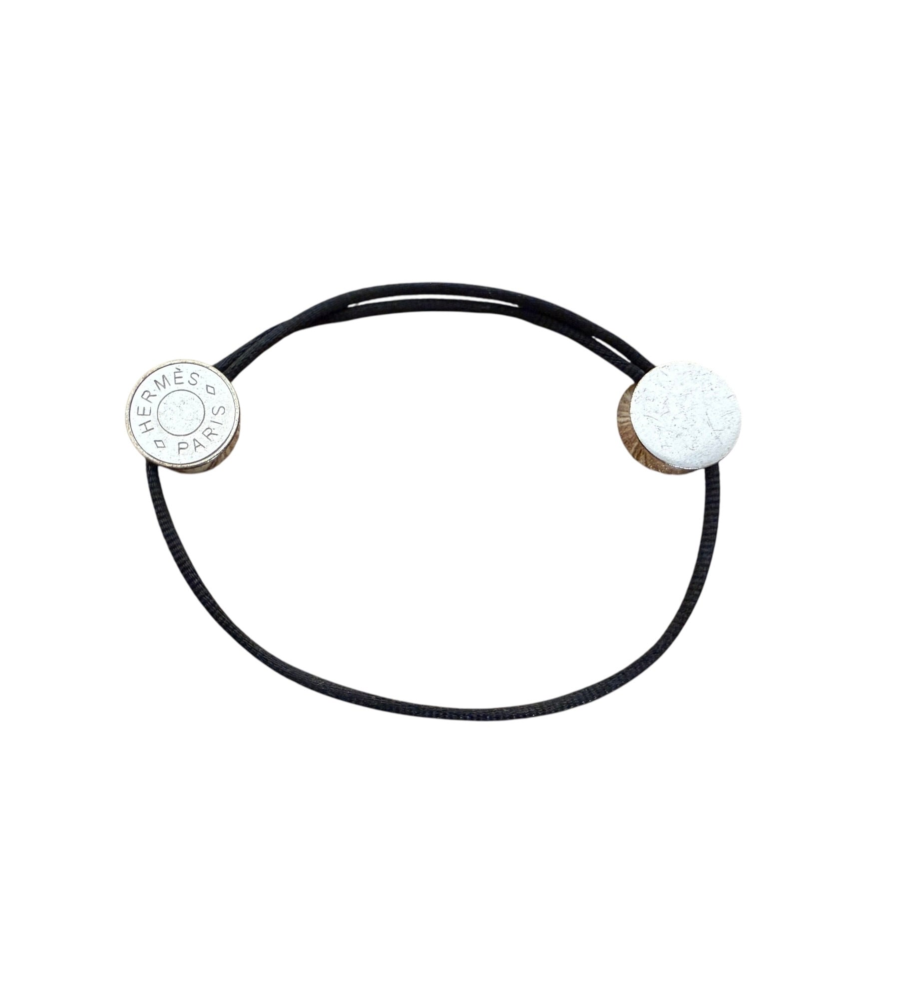 Hermès Clou de Selle adjustable black ord bracelet with engraved palladium-plated Hermès Paris hardware.